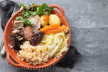 typical portuguese dish boiled meat, smoked sausages and vegetables on ceramic dish