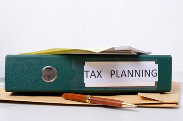 Paper work and process of tax planning.Folder, pen, documents on the desk against white background.Empty space