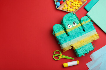 Flat lay composition with cardboard cactus and space for text on red background. Pinata diy © New Africa