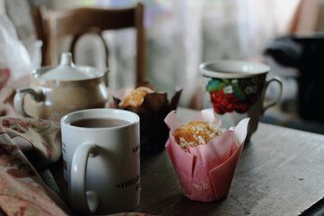 cup of coffee and muffin on wooden table