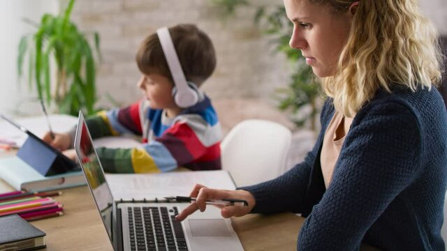 Video of mother during home office and son during homeschooling. Shot with RED helium camera in 8K.