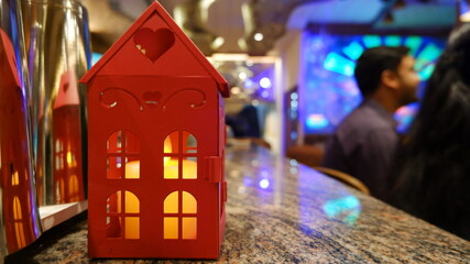 red toy house with a candle