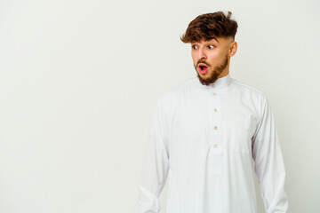 Young Moroccan man wearing a typical arab clothes isolated on white background being shocked because of something she has seen.