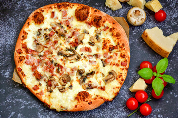 Tasty hot italian carbonara pizza with ham, bechamel sauce,mushroom,tomatoes  and cheese. Pizzeria menu. Concept poster for Restaurants or pizzerias. Top view