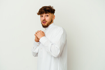 Young Moroccan man wearing a typical arab clothes isolated on white background scared and afraid.