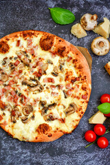 Tasty hot italian carbonara pizza with ham, bechamel sauce,mushroom,tomatoes  and cheese. Pizzeria menu. Concept poster for Restaurants or pizzerias. Top view