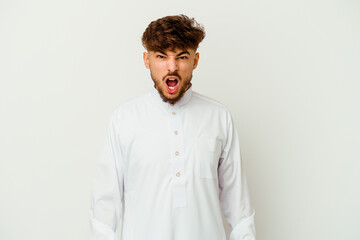Young Moroccan man wearing a typical arab clothes isolated on white background screaming very angry and aggressive.