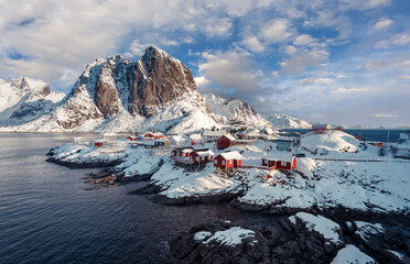 Fototapeta na wymiar Hamnoy fishing village on Lofoten Islands, Norway with red rorbu houses in winter. Concept of Travel and holiday on nature, tourist and fishing leisure. Iconic location for landscape photographers.