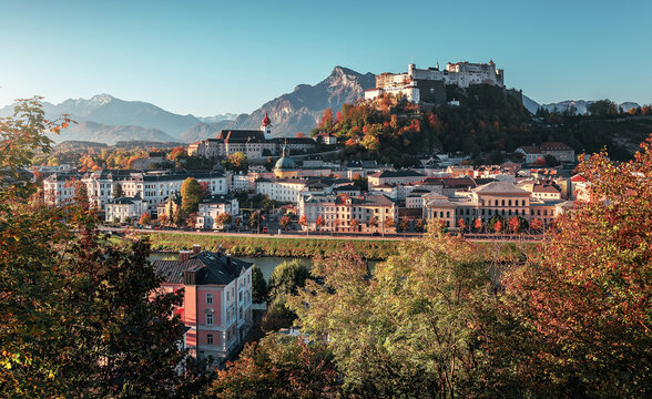 Incredible view of the historic city of Salzburg with famous Hohensalzburg Fortress at sunny day in Autumn. Popular travel and historical center of Austria. Concept ideal resting place. Creative image