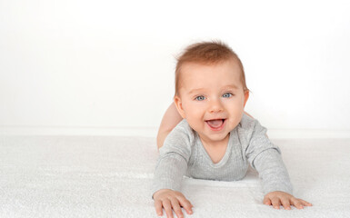 Fototapeta premium Portrait of a cute baby boy with blue eyes on white background