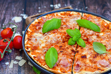  Close up of    hot italian pizza   classic ham. Fresh basil,tomato sauce ,mozzarella cheese , mushrooms and  minced meat .Concept poster for Restaurants or pizzerias. Top view