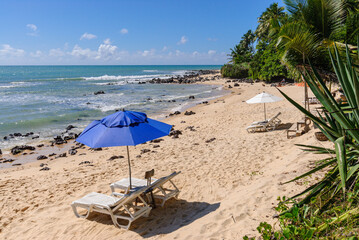 Blue parasol and chairs with nobody on the beach at Praia do Giz, Tibau do Sul, near Natal, Rio Grande do Norte, Brazil on June 6, 2010.