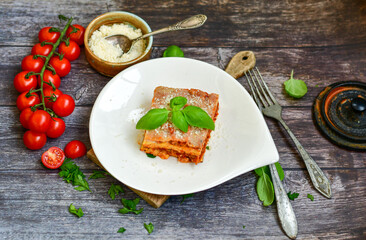   Delicious Home made keto diet  Lasagna bolognese  with  Lupin Flour, minced meat,tomato sauce and spinach  on a wooden rustic  background.Home made low carb italian meal