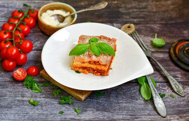   Delicious Home made keto diet  Lasagna bolognese  with  Lupin Flour, minced meat,tomato sauce and spinach  on a wooden rustic  background.Home made low carb italian meal