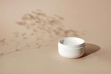 Moisturizer or nourishing cream. Concept of natural beauty products. Neutral backgrounds and hard shadows