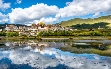 Fototapeta premium Songzanlin monastery panorama with lake and water reflection Shangri-La Yunnan China