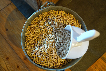 Bucket of Pellets, fuel for domestic biomass stoves. Selective focus in the center of the image