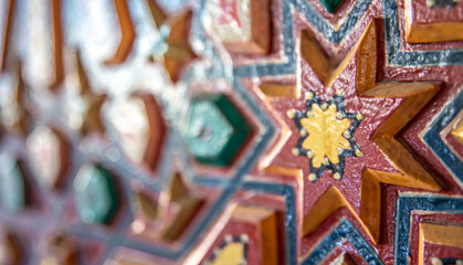 Fototapeta premium Close up of colored ornament on wood in traditional islamic style.