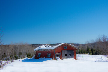 Very old garage in a field during Quebec winter in Canada