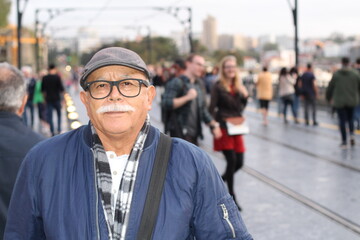 Senior man with a mustache in crowded street