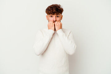 Young Moroccan man isolated on white background biting fingernails, nervous and very anxious.