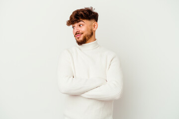 Young Moroccan man isolated on white background dreaming of achieving goals and purposes