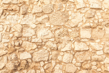 Background of ancient brick wall. Texture of old amphitheater stone. Texture of an ancient brick wall made of sandstone. Archaeological excavations
