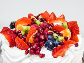 Anna Pavlova cake, cream and a variety of fruits. Strawberry, raspberry, currant, kiwi, jarberry, pomegranate!