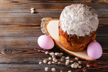 pink  eggs, willow twigs, Easter cake with icing on a dark wooden  top view