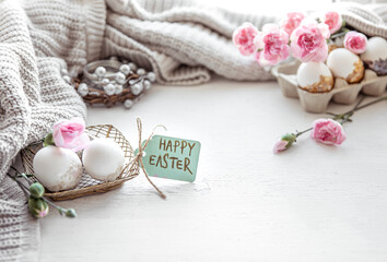 Festive Easter composition with eggs, flowers and the inscription Happy Easter copy space.