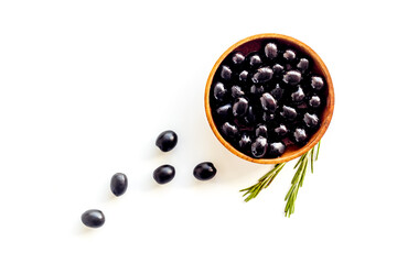 Black olives in wooden bowl. Overhead view