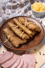 Pancakes on a plate with ham and cheese