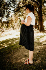 A pregnant woman in a park