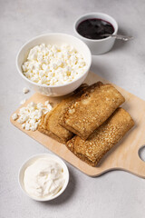 Pancakes roll on a light background close-up