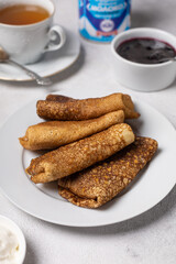 Pancakes on a plate on a light background