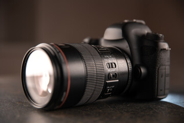 Close up in focus lens on the body of a professional digital camera.