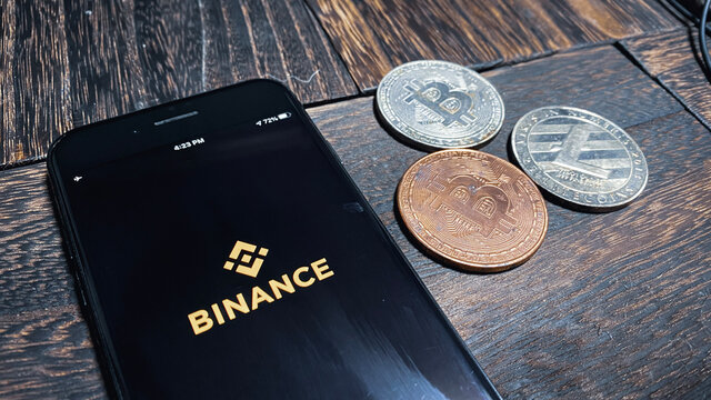 BINANCE log on screen of  iPhone. Bitcoin and Litecoin.Cryptocurrency exchange app/Fintech/Blockchain. Mar 2021/Japan