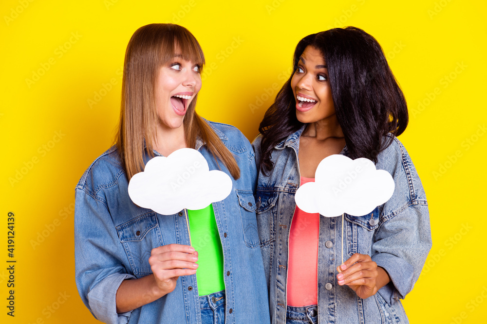 Wall mural photo of two astonished ladies arm hold cloud empty space card open mouth look each other isolated o