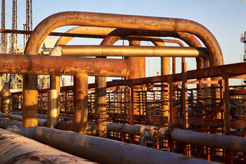 Tangle of gas collector steel pipes rust covered with traces of corrosion and aging. Concept of...