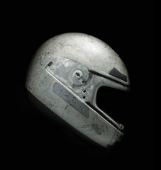 Empty cracked and damaged motorcycle helmet against black background. Clipping path