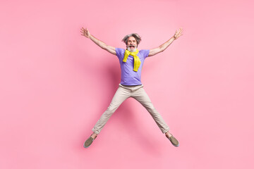 Fototapeta na wymiar Full length photo of aged man jump up have fun excited star tied sweater isolated over pastel color background