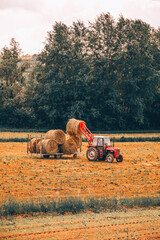 Farmer driving tractor on field. Agriculture concept. © Kitja