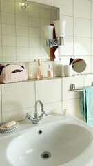Bathroom details, clean white washbasin with mirror and lighting