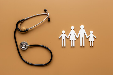 Medical care concept. Family figure with stethoscope, top view