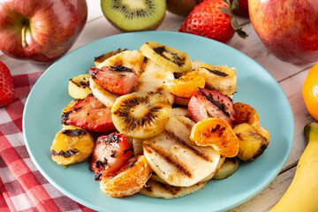 GRILLED FRUIT on a blue plate and white wooden table