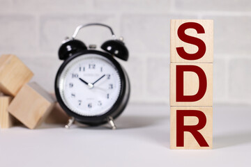 SDR - Special Drawing Rights. text on wood cubes. text in black letters on wood blocks