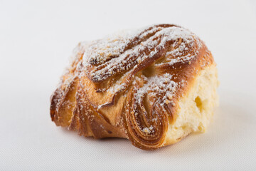Sweet freshly baked bun on a white background, isolated.