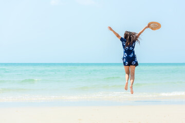 Summer vacations. Lifestyle woman relax and chill on beach background.  Asia happy young people jumping on the wave sea, summer trips walking enjoy  tropical beach