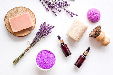 Fototapeta na wymiar Flat lay of lavender cosmetics - bath salt and essential oil, top view