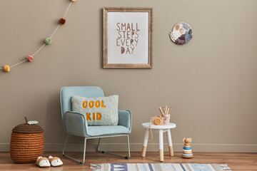 Cozy interior of child room with mint armchair, brown mock up poster frame, toys, teddy bear, plush...